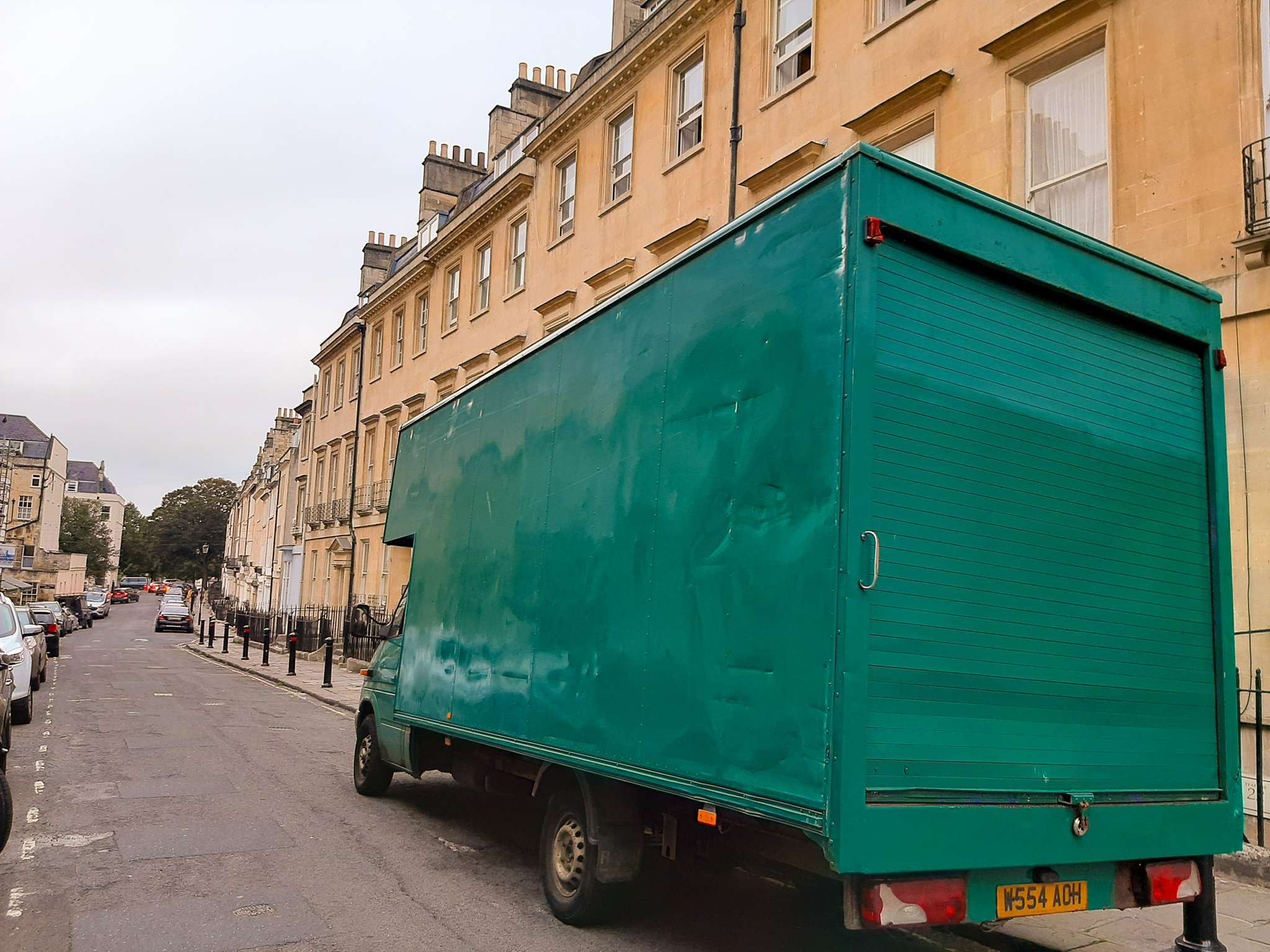Removal team carefully loading furniture outside a Georgian Bath townhouse