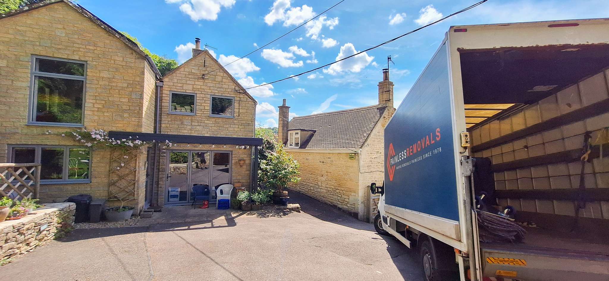 Removal van at a Cotswold stone property