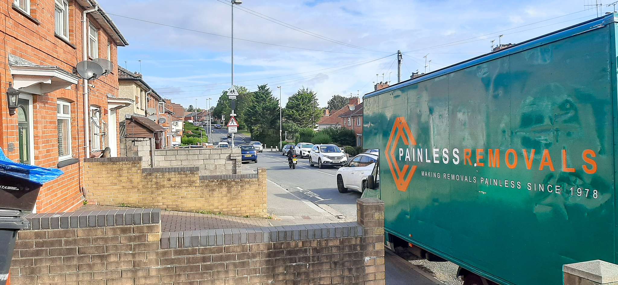 Painless Removals team loading a van outside a 1930s semi-detached house in Knowle, Bristol