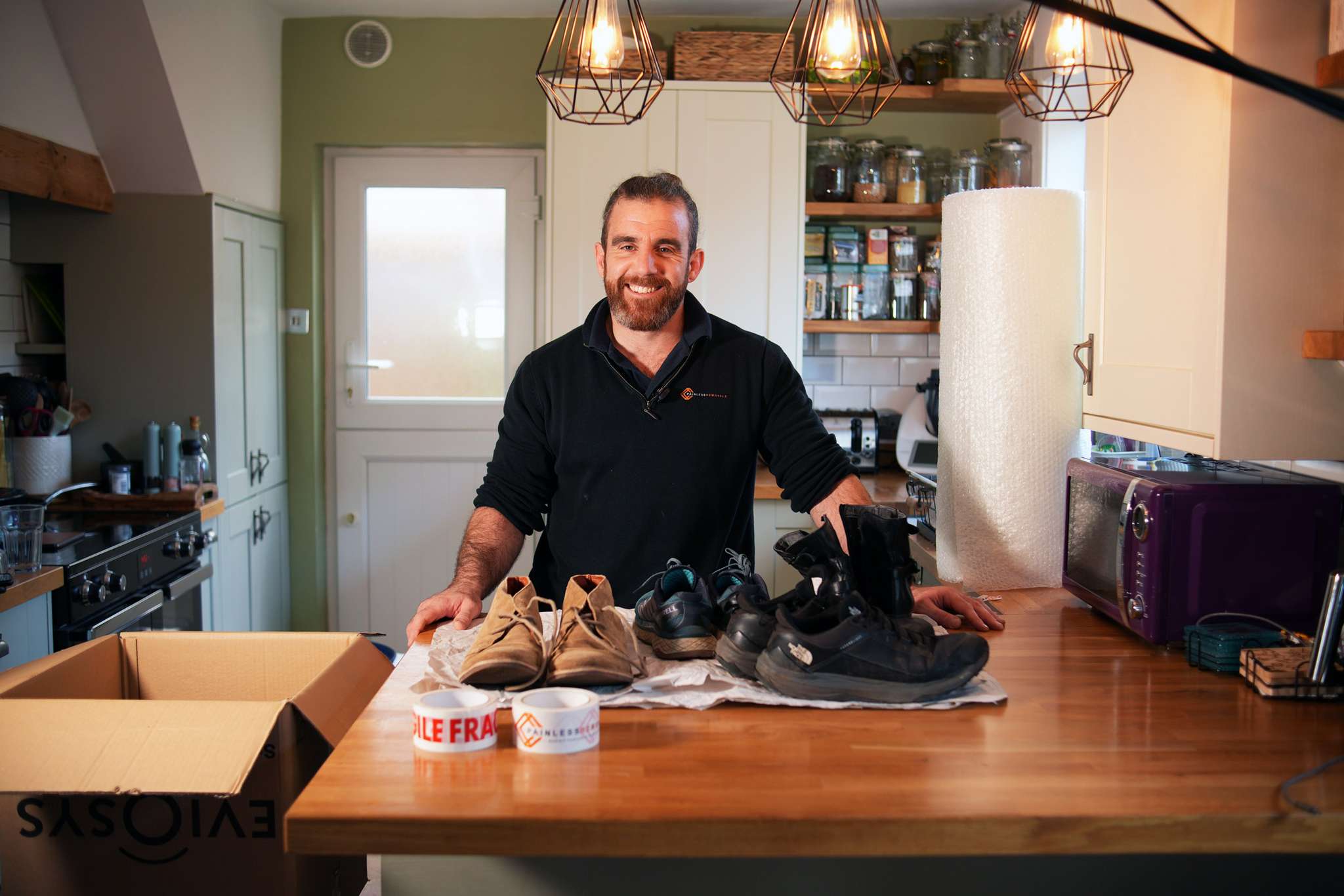 Jay Newton demonstrating professional packing techniques in a kitchen