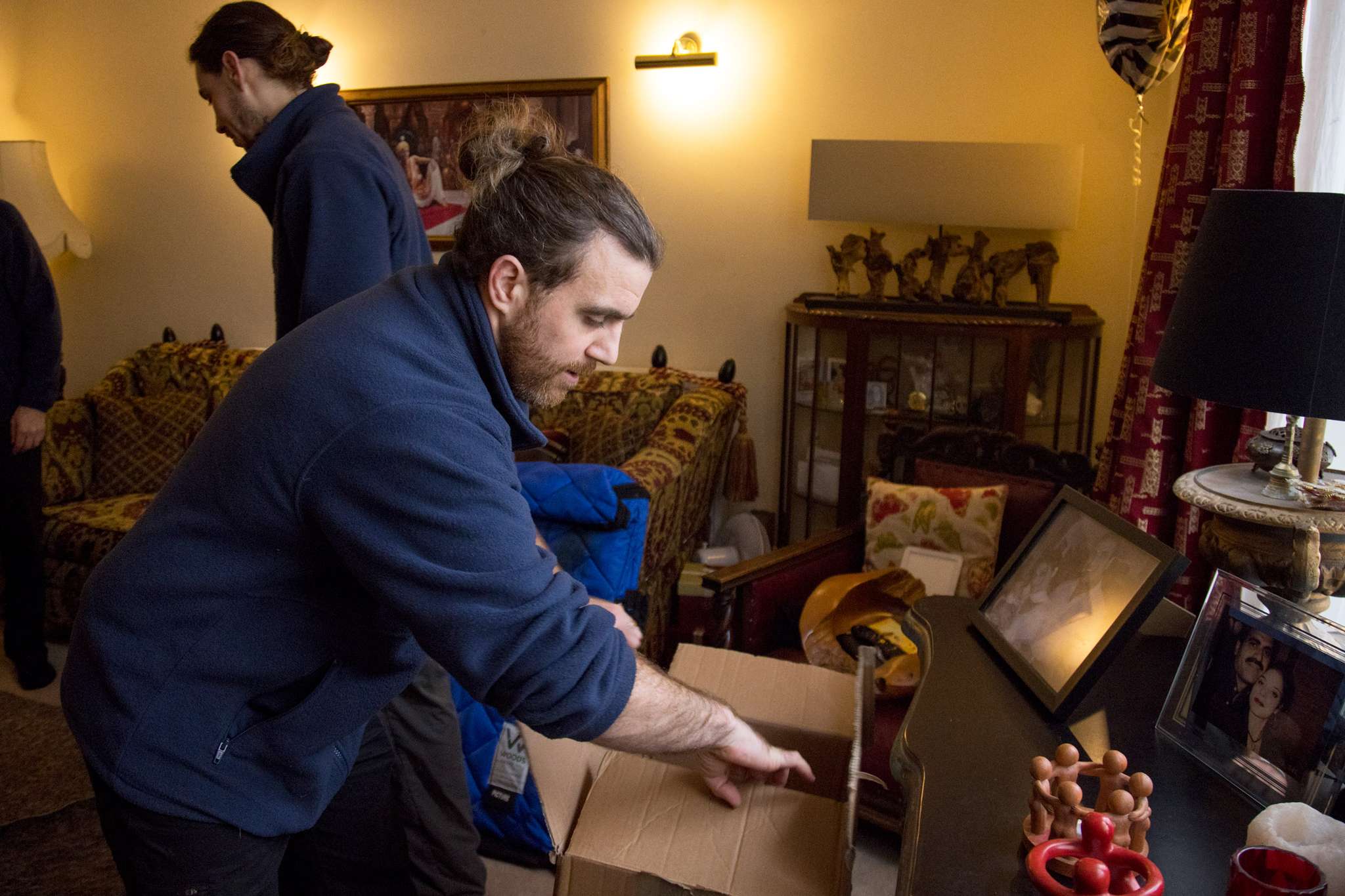 Professional packing service team carefully wrapping and boxing household items